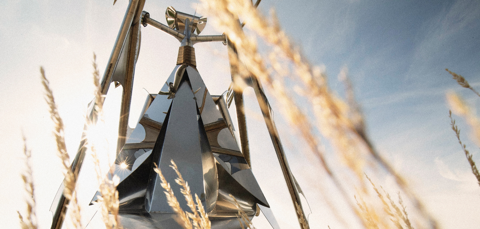 Mantis Queen sculpture with sun shining in background